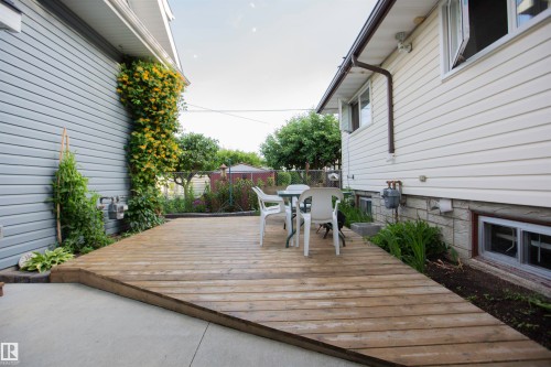Expansive wood deck with a concrete patio extension - 11131 52 Street Nw, Edmonton, AB - Outdoor With Exterior