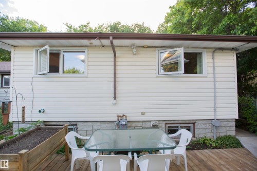 Rear exterior featuring white vinyl siding and a wood-finish deck - 11131 52 Street Nw, Edmonton, AB - Outdoor With Deck Patio Veranda With Exterior
