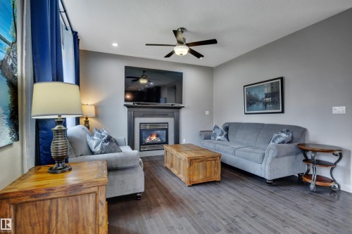 3812 Triomphe Boulevard, Beaumont, AB - Indoor Photo Showing Living Room With Fireplace
