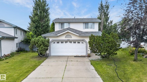 Two-story home featuring a white exterior with peaked roofline and architectural detailing - 12724 148 Avenue Nw, Edmonton, AB - Outdoor