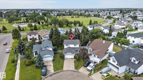 Two-story residence with an attached double-car garage, mature landscaping, and a paved driveway - 12724 148 Avenue Nw, Edmonton, AB - Outdoor With View