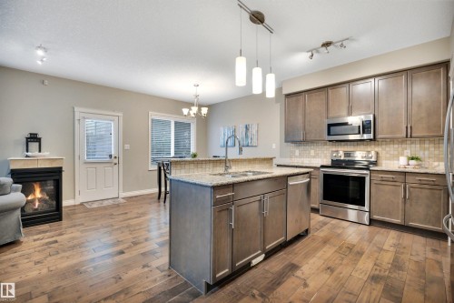 208 Bridgeport Close, Leduc, AB - Indoor Photo Showing Kitchen With Fireplace With Double Sink With Upgraded Kitchen