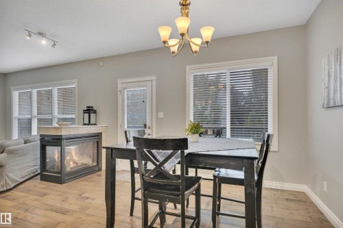 208 Bridgeport Close, Leduc, AB - Indoor Photo Showing Dining Room With Fireplace