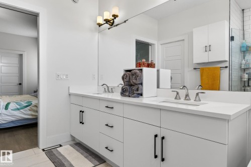 Dual vanity with white cabinetry and black hardware - 45 Evermore Crescent, St. Albert, AB - Indoor Photo Showing Bathroom