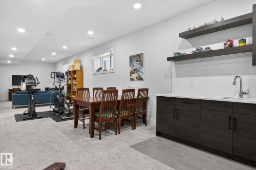 Recessed lighting, wood-finish cabinetry, quartz-finish countertop, subway tile backsplash, and floating shelves - 45 Evermore Crescent, St. Albert, AB - Indoor Photo Showing Dining Room