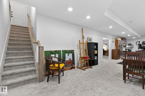 Carpeted staircase with wood handrail, recessed lighting, and wall-to-wall carpeting - 45 Evermore Crescent, St. Albert, AB - Indoor Photo Showing Other Room
