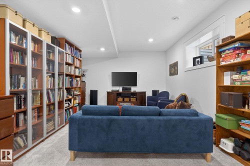 Recessed ceiling lighting, wood-finish built-in shelving, carpet flooring, and a horizontal window - 45 Evermore Crescent, St. Albert, AB - Indoor