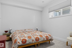 Recessed ceiling lighting, window with horizontal blinds, light-toned carpeting, white wall finishes, and white trim - 