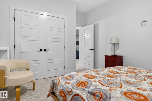 Recessed ceiling lighting, white interior doors with black hardware, and light-colored carpeted flooring - 45 Evermore Crescent, St. Albert, AB - Indoor Photo Showing Bedroom