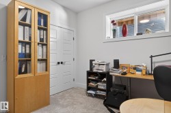 Light-toned carpeting, white walls, and a built-in window - 
