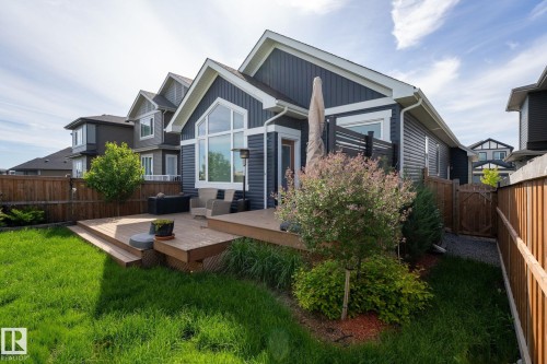 Expansive backyard featuring a multi-level wood deck, manicured lawn, and mature privacy fencing - 45 Evermore Crescent, St. Albert, AB - Outdoor