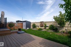 Expansive outdoor deck with multi-level design and slatted privacy screen - 
