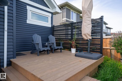 Wood-finish deck with steps, privacy screen, and dark siding with white trim - 45 Evermore Crescent, St. Albert, AB - Outdoor