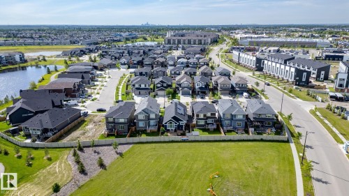 Residential development featuring a variety of detached homes and townhomes, surrounded by green spaces and a pond - 45 Evermore Crescent, St. Albert, AB - Outdoor With View