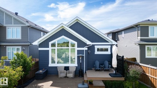 Rear exterior featuring a large deck, prominent arched window, and durable siding - 45 Evermore Crescent, St. Albert, AB - Outdoor