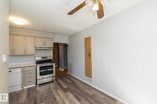 Kitchen with light gray cabinetry, stainless steel range and dishwasher, and a tiled backsplash - 12322 94 Street Nw, Edmonton, AB - Indoor Photo Showing Kitchen