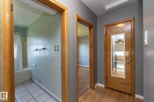 Wood-finish flooring with a neutral wall color palette - 12322 94 Street Nw, Edmonton, AB - Indoor Photo Showing Other Room