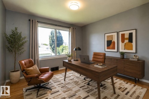 Recessed lighting with a flush-mount fixture, wood-finish flooring, and a large window with drapes - 12322 94 Street Nw, Edmonton, AB - Indoor