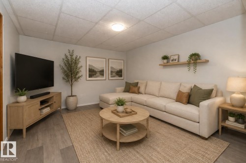 Recessed lighting, wood-finish flooring, drop ceiling, light-toned wall paint, and a built-in wall shelf - 12322 94 Street Nw, Edmonton, AB - Indoor Photo Showing Living Room
