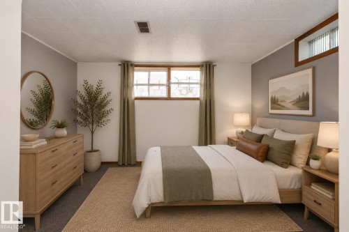 Accent wall with framed artwork, natural wood-finish window trim, and a high-set horizontal window - 12322 94 Street Nw, Edmonton, AB - Indoor Photo Showing Bedroom