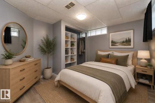Wood-finish flooring, recessed lighting, built-in shelving, and a glass block window - 12322 94 Street Nw, Edmonton, AB - Indoor Photo Showing Bedroom