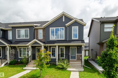 Two-story exterior featuring dark gray siding and light trim - 7109 Chivers Close Sw, Edmonton, AB - Outdoor With Facade