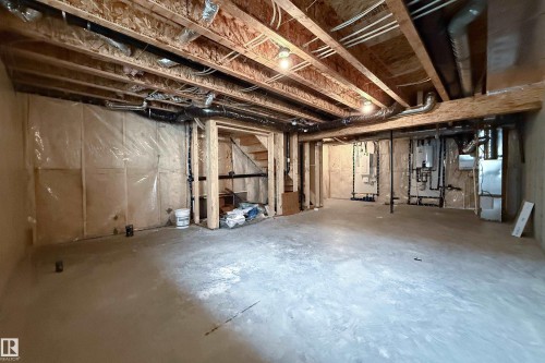 Unfinished basement offering exposed wood framing, concrete flooring, and visible plumbing and electrical infrastructure - 7109 Chivers Close Sw, Edmonton, AB - Indoor Photo Showing Basement