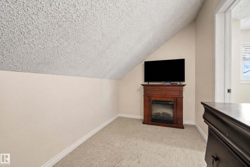 Extra space for desk or TV just off the third bedroom. - #25 3811 85 St Nw, Edmonton, AB - Indoor With Fireplace