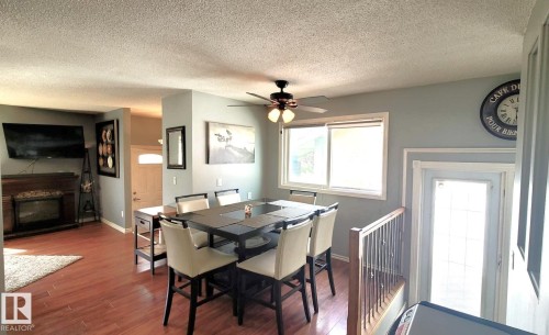 18 Westbend Street, Spruce Grove, AB - Indoor Photo Showing Dining Room With Fireplace