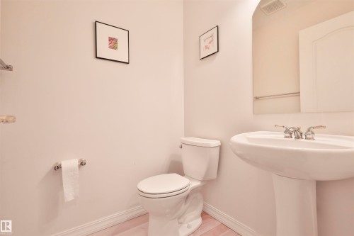 Pedestal sink with chrome hardware and a wall-mounted mirror - 237 Darlington Crescent Nw, Edmonton, AB - Indoor Photo Showing Bathroom