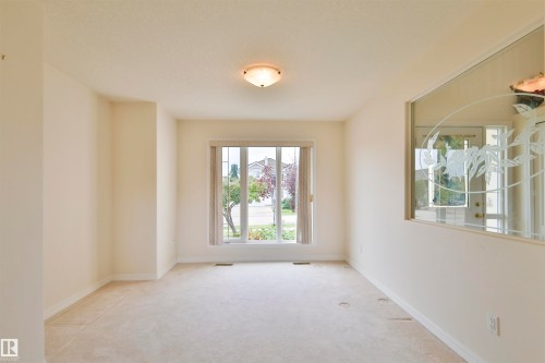 Recessed window with exterior views and a frosted glass architectural feature - 237 Darlington Crescent Nw, Edmonton, AB - Indoor Photo Showing Other Room