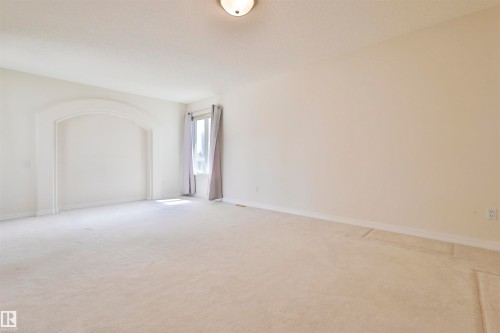 Arched wall niche and recessed window with drapes - 237 Darlington Crescent Nw, Edmonton, AB - Indoor Photo Showing Other Room