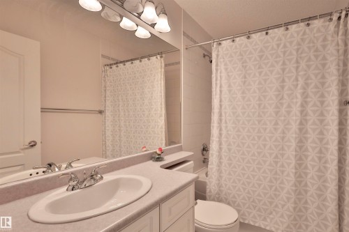 Vanity with an integrated sink, polished chrome faucet, and storage cabinetry - 237 Darlington Crescent Nw, Edmonton, AB - Indoor Photo Showing Bathroom