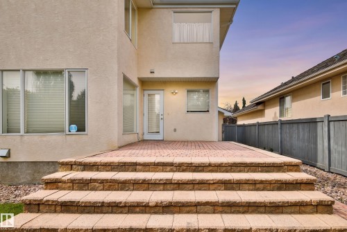 Stone paver patio with matching tiered steps, stucco exterior, and a privacy fence - 237 Darlington Crescent Nw, Edmonton, AB - Outdoor With Exterior