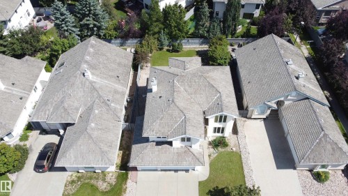 Gabled roofline with light-colored shingles, multiple dormer windows, and a prominent chimney feature - 237 Darlington Crescent Nw, Edmonton, AB - Outdoor