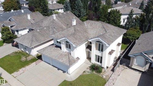 Two-story residence featuring a shingled roof, attached garage, and a concrete driveway - 237 Darlington Crescent Nw, Edmonton, AB - Outdoor
