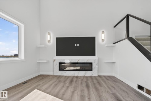 102 Eldridge Point(E), St. Albert, AB - Indoor Photo Showing Other Room With Fireplace