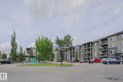 Multi-story residential building with private balconies and exterior stone accents - #321 270 Mcconachie Dr Nw, Edmonton, AB - Outdoor With Balcony