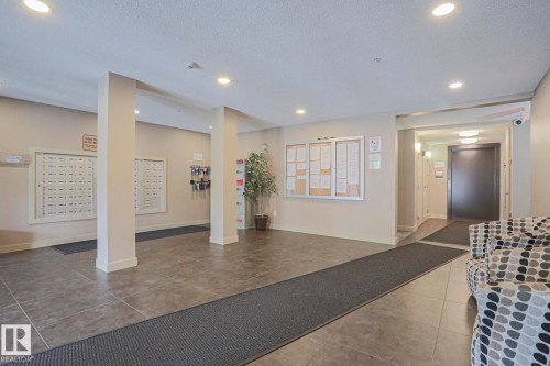 Common area featuring recessed lighting, tile flooring, and a bulletin board - #321 270 Mcconachie Dr Nw, Edmonton, AB - Indoor Photo Showing Other Room