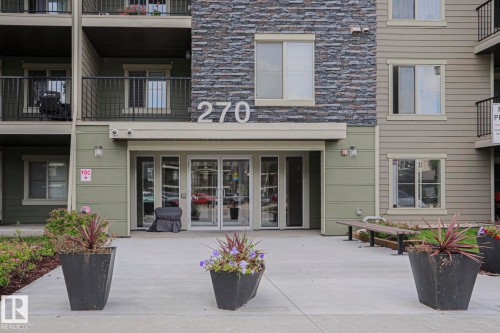 Building exterior featuring stone-look accent siding and neutral-toned horizontal siding - #321 270 Mcconachie Dr Nw, Edmonton, AB - Outdoor With Balcony