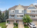 Three-story townhouse featuring blue horizontal siding with white trim, a gabled roofline, and attached garages - #53 603 Watt Bv Sw, Edmonton, AB  - Outdoor With Facade 
