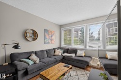 Living area featuring light gray walls and wood-finish flooring - 