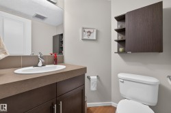 Bathroom vanity with a rectangular undermount sink, chrome faucet, and brown countertop - 