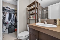 Bathroom vanity featuring a single basin, chrome faucet, and brown countertop - 