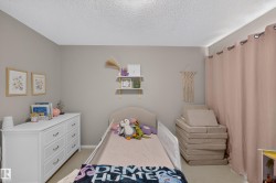 Neutral-toned walls complement the textured ceiling - 