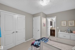Neutral-toned room featuring a flush-mount ceiling light and two-panel interior doors - 