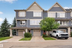 Townhome exterior featuring blue siding with light beige trim accents - 