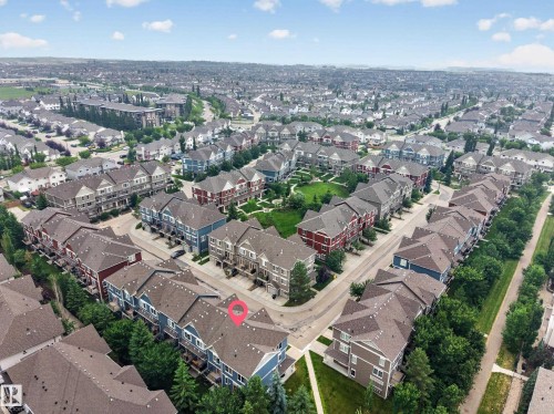 Expansive aerial overview of a residential development featuring numerous townhome-style properties - #53 603 Watt Bv Sw, Edmonton, AB - Outdoor With View