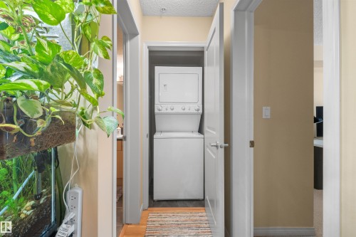 Stackable washer and dryer unit - #209 103 Ambleside Drive Sw, Edmonton, AB - Indoor Photo Showing Laundry Room