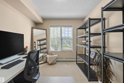 Beige wall paint, textured ceiling, window with white blinds, wall-to-wall carpet flooring - #209 103 Ambleside Drive Sw, Edmonton, AB - Indoor